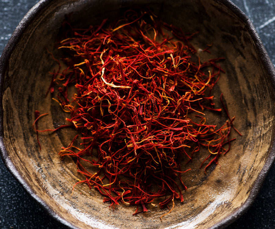 Close-up of saffron threads on a textured surface