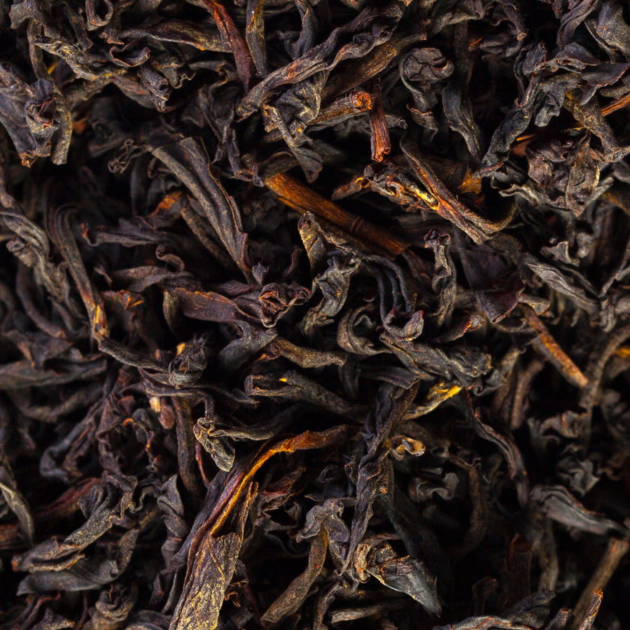 Detailed close-up of dried black tea leaves, as used in Krocus & Co. Earl Grey black tea